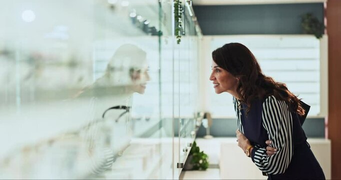 Happy woman, shelf and customer at optometry store for frame choice, vision correction or fashion lens. Client, smile and spectacles in optical shop for decision, eye care or check glasses for health