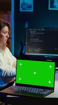 Vertical video Programmer designing and developing software applications using isolated screen laptop. IT professional implementing and maintaining company systems using mockup notebook, camera B