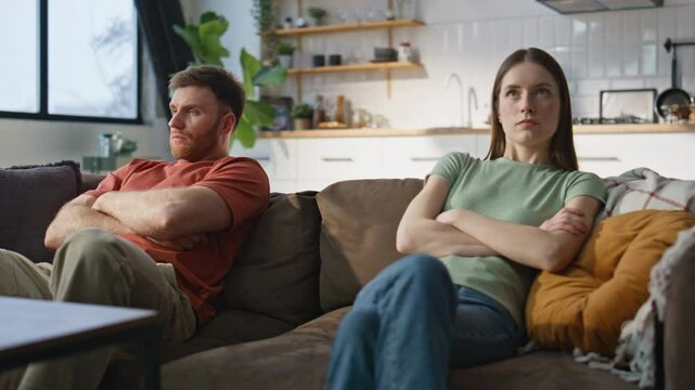 Married couple resent sitting separately home couch closeup. Frustrated partners