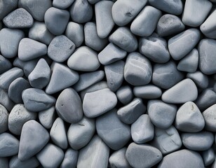 Grey granite pebbles washed smooth by the sea, a textured pattern