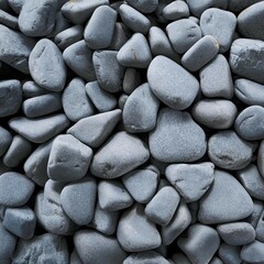 Grey granite pebbles washed smooth by the sea, a textured pattern