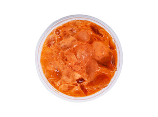 Iced milk tea color orange with crushed ice in glass plastic on top corner. Refreshing drink is popular in tropical countries. Isolated on cut out PNG. Old-fashioned drink in tropical.