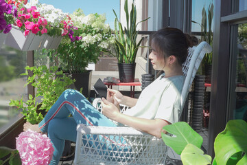 A woman is reading on the balcony
