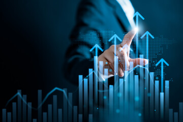 Businesswomen pointing to arrow up virtual to forecast and analyze the stock market and economic...