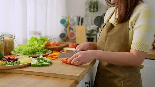 Close up of woman cooking healthy foods in kitchen in morning at home. 