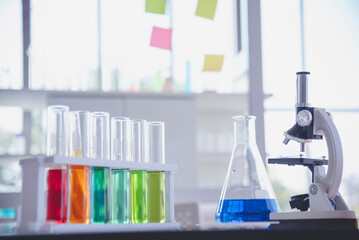 Science laboratory chemistry test science lab with microscope, glass tubes, chemical beaker white table scientific background. Colorful Liquid biology laboratory chemical fluid scientist experiment
