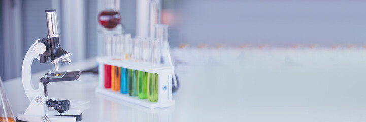 Banner Science laboratory chemistry test science lab with microscope glass tubes chemical beaker scientific background. Colorful Liquid biology laboratory fluid scientist experiment with copy space © aFotostock