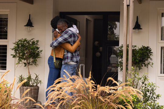 Hugging, african american couple reuniting at home, expressing love and happiness, copy space