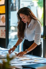 A female event planner coordinating a product launch event. She&rsquo;s working with the marketing team and setting