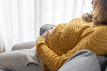 Obraz premium Pregnant woman holds hands on belly touching her baby caring about her health Beautiful happy pregnant woman&nbsp;.tender mood photo of pregnancy.