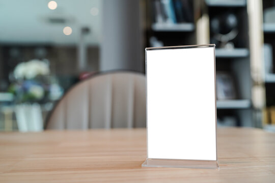 Menu&nbsp;mack up blank for text marketing promotion. Mock up Menu frame standing on wood table in restaurant space for text.