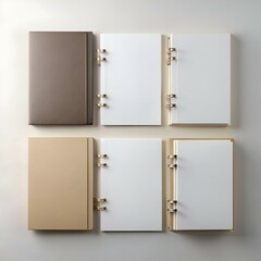 Four blank notebooks. each with a different cover. lay flat on a white background.