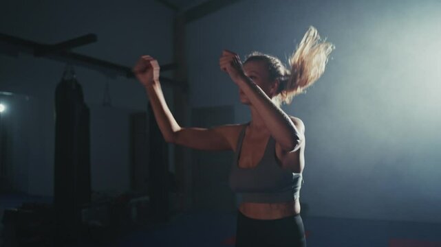 Capture the energy of a dancer performing in a dimly lit studio at night