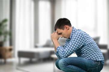 Portrait of upset depressed man in living room