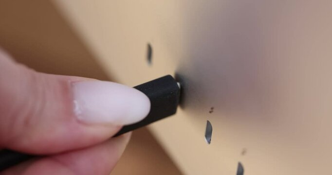 Close-up of manually connecting USB cable