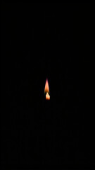 Single candle flame in the dark