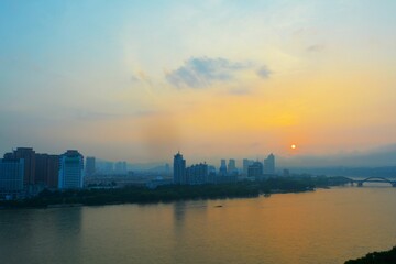Fototapeta premium City sunrise through fog with sunspots