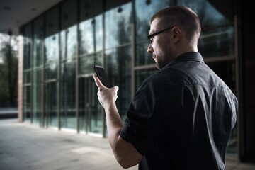 Portrait of smiling ceo manager using smartphone