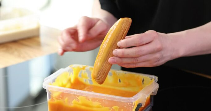 Delicious eclair covered with yellow glaze.