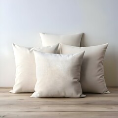 Four pristine white pillows arranged on a light wood surface. creating a minimalist and inviting atmosphere.