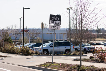 Bike lane ends black and white street sign on metal. High quality picture for download