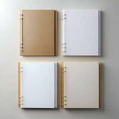 Four blank notebooks with different colored covers lay flat. ready for your designs!  Great for showcasing branding. mockups. or creative projects.