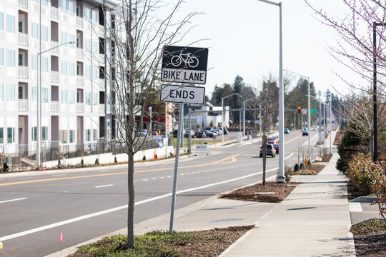 Bike lane ends black and white street sign on metal. High quality picture for download