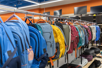 A rack of backpacks is hanging from the ceiling