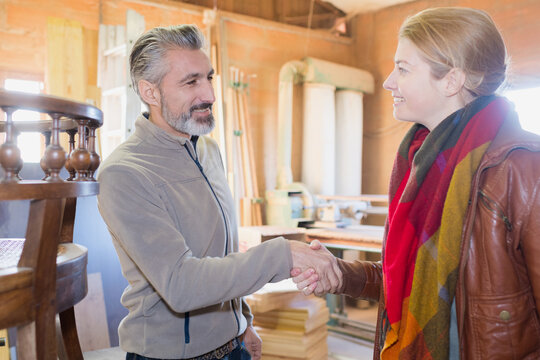 seller giving a handskake to happy customer