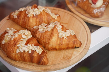 Croissants with different fillings are laid out on a round tray.