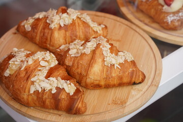 Croissants with different fillings are laid out on a round tray.