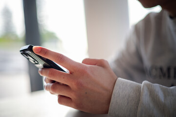 Close up man using smart phone, Social media marketing concept. hand using smartphone typing, chatting conversation in chat box icons pop up