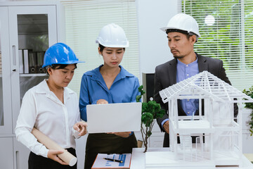 A team of architects and engineers work together in brainstorming sessions, discussing blueprints and construction plans for a real estate development.