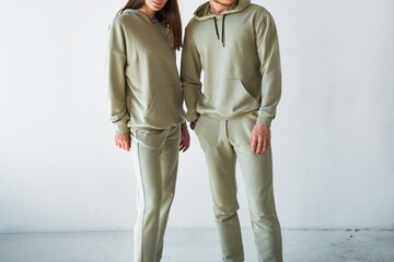 Man and woman in comfortable green hoodies and pants