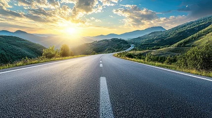 Fotobehang beautifully curved asphalt road stretching through a scenic landscape at sunset. The road is bordered by lush green trees and mountains © ttonaorh