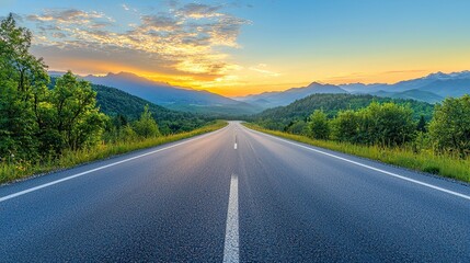 Naklejka premium beautifully curved asphalt road stretching through a scenic landscape at sunset. The road is bordered by lush green trees and mountains