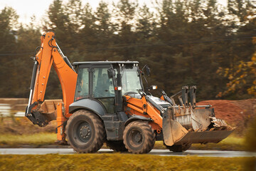 Backhoe loader performing roadside construction tasks