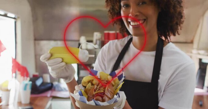 Serving hot dog with mustard, heart animation over smiling vendor