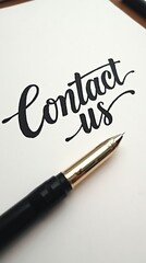 Calligraphy text 'Contact Us' with fountain pen on paper