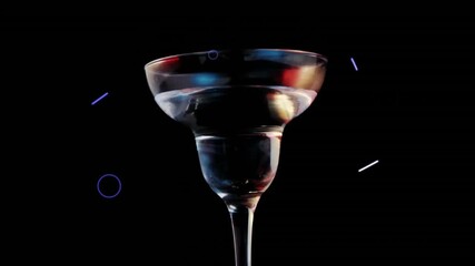 Martini glass with colorful reflections over geometric shapes animation on black background - Powered by Adobe