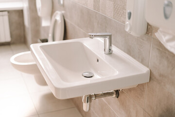 Modern bathroom sink with chrome faucet and tile backsplash
