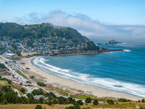 Aerial image of the Pacifica State Beach in Pacifica, California on a beautiful summer day with blue sky and blue water and a sandy beach