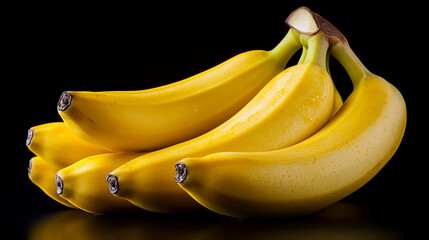 A vibrant bunch of ripe bananas against a dark background, highlighting their smooth texture and bright yellow color.