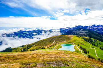 View from Schatzberg of the surrounding landscape. Idyllic nature in Wildschönau in the Kufstein district in Austria. Mountain landscape in the Kitzbühel Alps in Tyrol.
