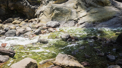 Beautiful view of rocky river flow nearest the Tumpak Sewu Waterfall in East Java, Indonesia