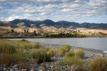 Rolling hill and a scenic rocky shore of Issyk-Kul lake