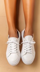 The composition features a close-up of a woman's legs laid flat, showcasing white sneakers on a...