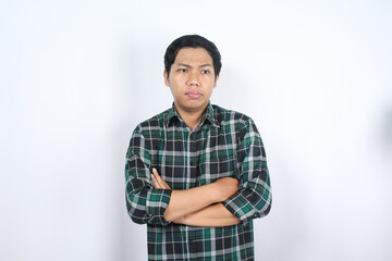uncertain asian young man arms crossed thinking and considering decision isolated
