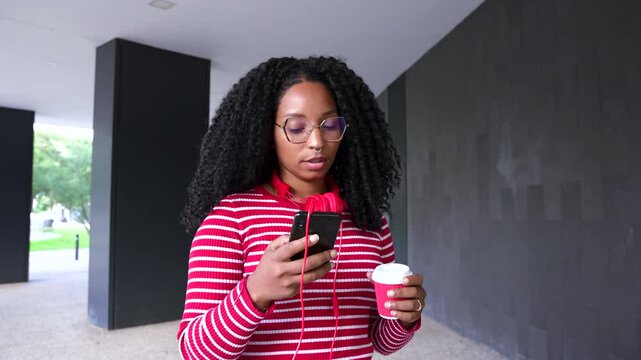  Young African American woman browsing the Internet smart mobile application