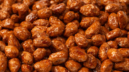 Tasty sweet roasted peanuts as a background.